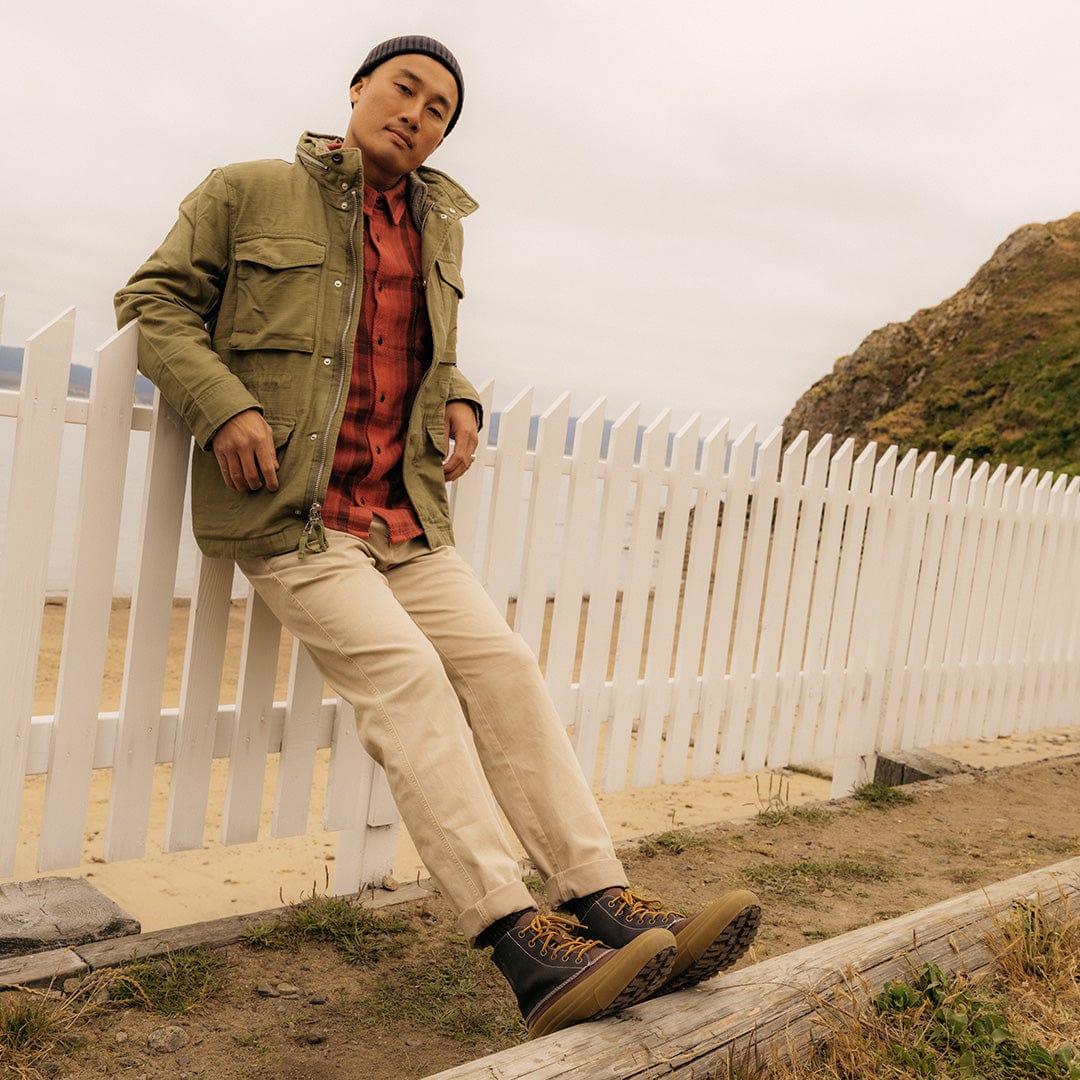 Stylish outdoor look featuring a man standing in Hickory/Charcoal Cascade Range Boots, paired with a light jacket and jeans.