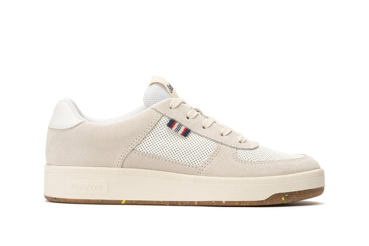 Side view of the Cardinal Sneaker in White, showcasing the blue, red, and white tag and mesh detailing on the side of the shoe and thick white sole