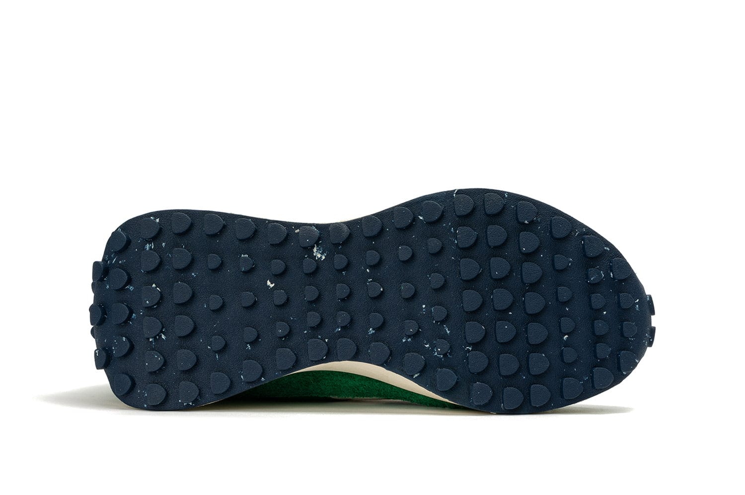 View of the sole of the Acorn Trainer in the color Grass Green, showcasing the recycled material sole.