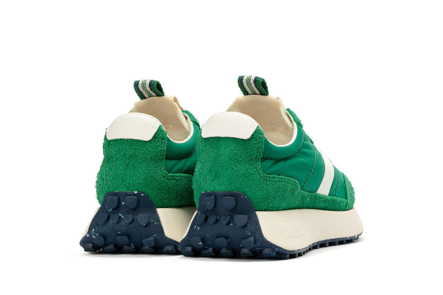 Rear-angled view of the Acorn Trainer in Grass Green, showcasing the pull tab and recycled material sole.