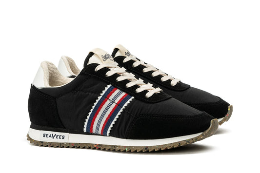 Angled view of Royal Runner sneakers in Black, featuring SeaVees on sole and tongue and recycled bottom.
