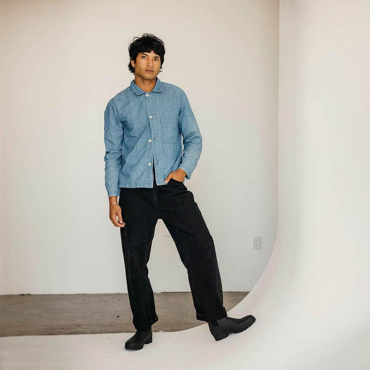 Men's Bolinas Off Shore Boot in Black rubber, worn with black pants, full-length view against a white wall