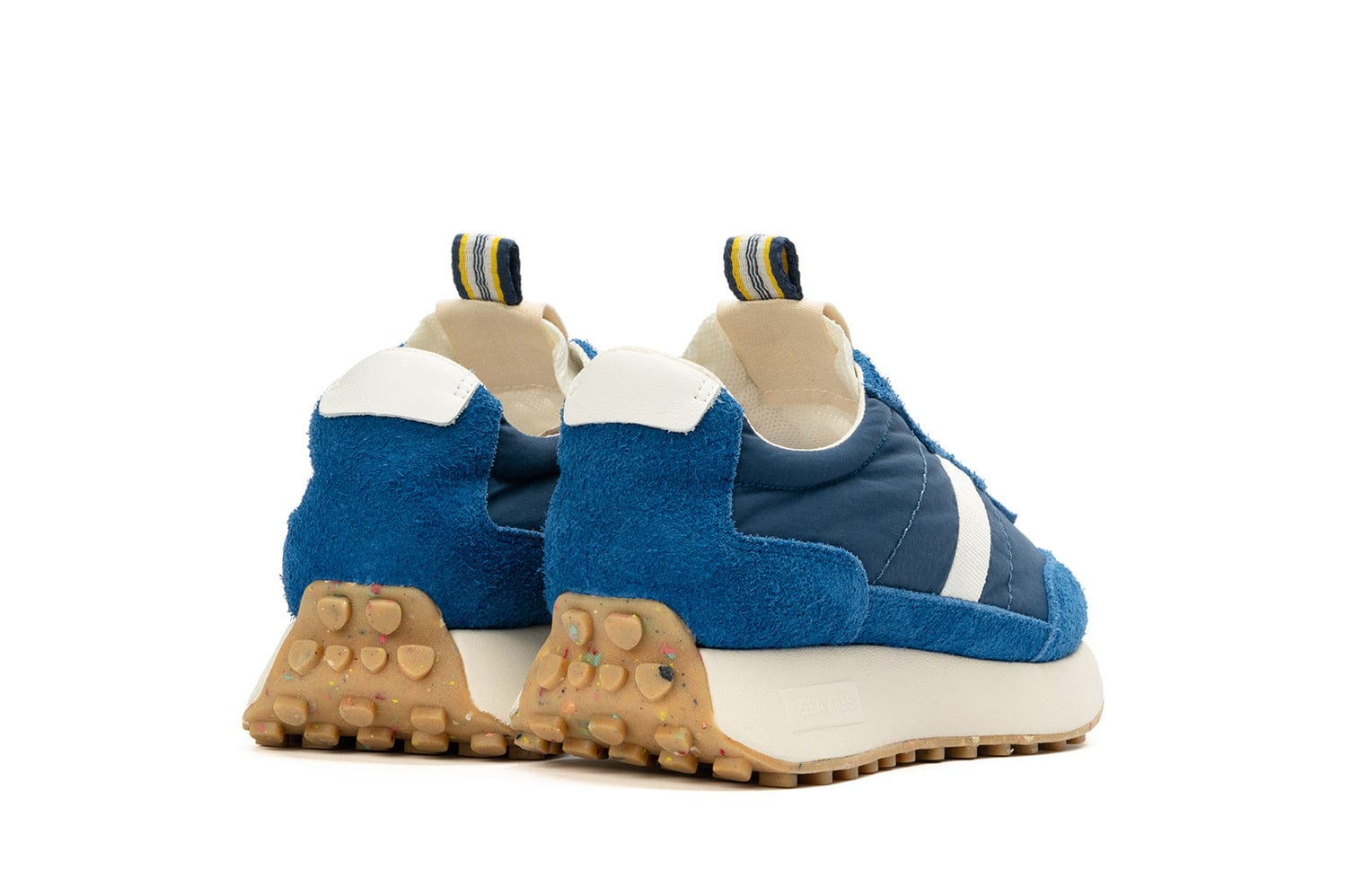 A rear-angled view of the Acorn sneaker in Varsity Blue, showcasing the pull tab and colorful sole.