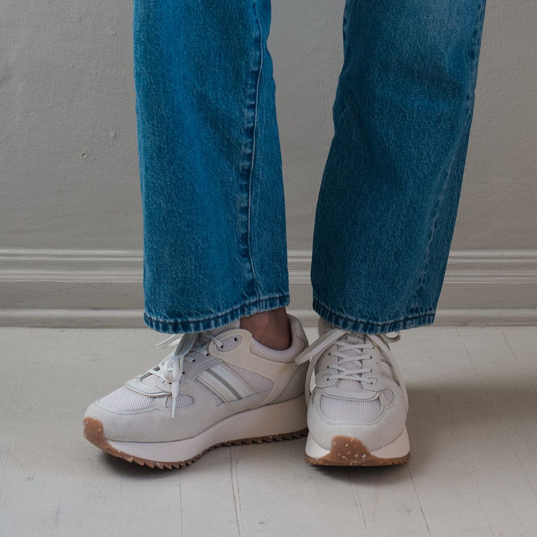 Women's Causeway Trainer sneaker in Cloud mesh and leather, worn with wide-leg jeans, front view