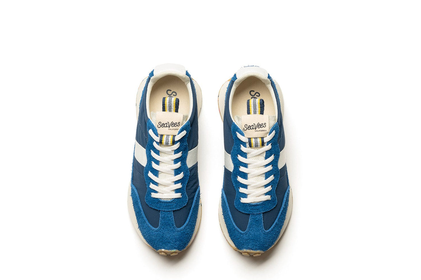 Top-down view of the Acorn Trainer in the color Varsity Blue, showcasing white laces and branding.