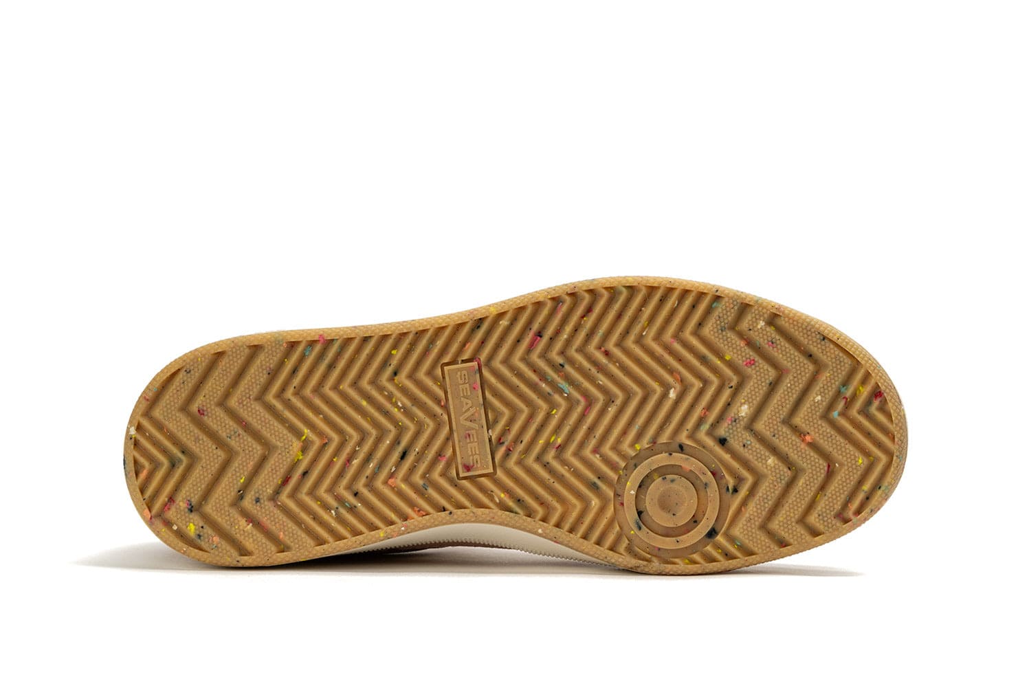 View of the Cardinal Sneaker in Pink Sand laying on its side, showcasing the recycled material sole