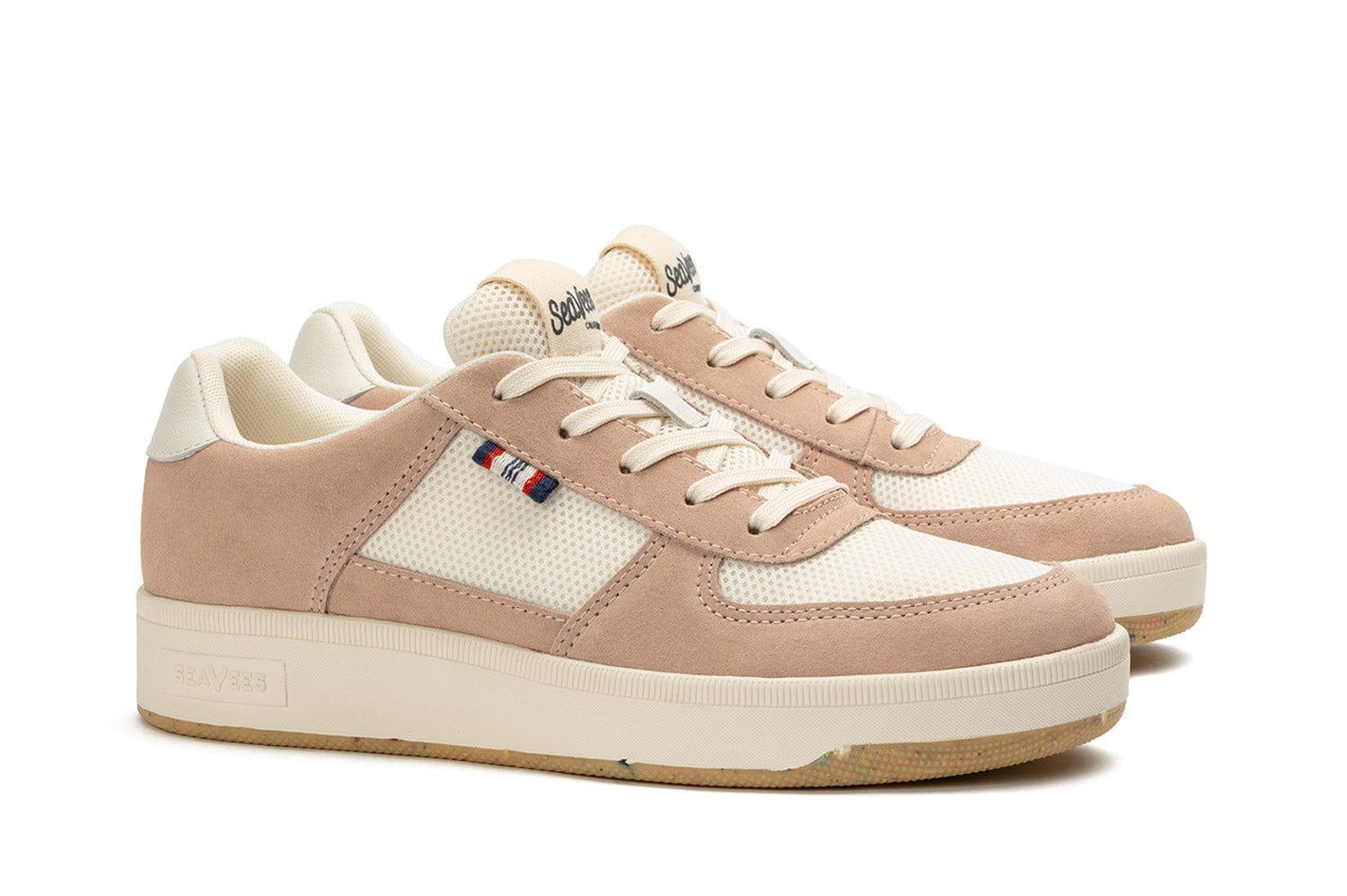 Slightly angled side view of the Cardinal Sneaker in Pink Sand, showcasing the white laces and vintage-style branded tongue