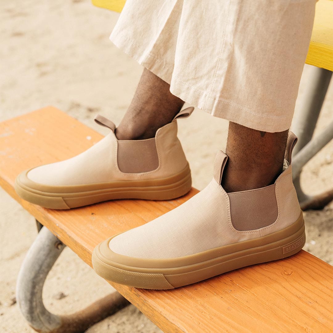 Person sitting on bench wearing Stone Ballard Boots with linen pants.